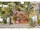 Aerial view of a property with a square lot and surrounding neighborhood homes at 14329 14Th St, Dade City, FL 33523
