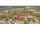 Gorgeous aerial view of a neighborhood dotted with houses and tree cover at 14329 14Th St, Dade City, FL 33523