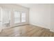 Bedroom with wood-look flooring and bright, neutral walls at 14329 14Th St, Dade City, FL 33523
