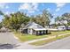 Charming home featuring a fenced yard, lush lawn, and established trees at 14329 14Th St, Dade City, FL 33523