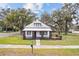 Quaint home showcasing a welcoming porch and manicured lawn at 14329 14Th St, Dade City, FL 33523