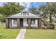 Inviting home with a columned porch and neat landscaping in a neighborhood setting at 14329 14Th St, Dade City, FL 33523