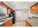 Bright kitchen featuring tiled flooring and wood cabinets at 14329 14Th St, Dade City, FL 33523