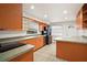 Bright kitchen with stainless steel appliances and wood cabinetry at 14329 14Th St, Dade City, FL 33523