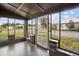 Enclosed screened porch with brick accents, offering a view of the yard at 14329 14Th St, Dade City, FL 33523