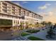 Upscale building with street-level shops, greenery, and pedestrian walkways for an urban lifestyle at 15000 Madeira Way # 622, Madeira Beach, FL 33708