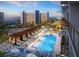 Luxurious resort pool area featuring lounge chairs, umbrellas, and a poolside bar with ocean views at 15000 Madeira Way # 741, Madeira Beach, FL 33708