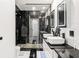 Contemporary bathroom with black marble, dual sinks, and a glass shower at 151 Sea Horse Se Dr # D, St Petersburg, FL 33705