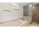 Bathroom with tiled tub, shower, and glass shelves at 1740 Shady Leaf Dr, Valrico, FL 33596