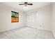 Inviting bedroom featuring carpet, a ceiling fan, and a spacious closet for storage at 1740 Shady Leaf Dr, Valrico, FL 33596