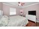 Bedroom features a ceiling fan, a television, and a dresser at 2580 Redwood Way, Clearwater, FL 33761