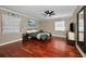 Spacious bedroom featuring hardwood floors, two large windows, and a ceiling fan at 2580 Redwood Way, Clearwater, FL 33761