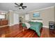 Bedroom with a ceiling fan, hardwood floors, and ensuite bathroom at 2580 Redwood Way, Clearwater, FL 33761