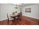 Traditional dining room with dark wood floors and decorative chandelier at 2580 Redwood Way, Clearwater, FL 33761