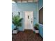 Inviting front entrance with brick accents, a white door, and tasteful landscaping at 2580 Redwood Way, Clearwater, FL 33761