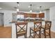 Gourmet kitchen with granite countertops, stainless appliances, and bar seating at 2580 Redwood Way, Clearwater, FL 33761