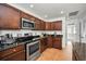 Kitchen with stainless steel appliances, granite countertops, and dark wood cabinetry at 2580 Redwood Way, Clearwater, FL 33761