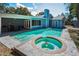 Aerial view of the pool with attached spa, covered patio and backyard at 2580 Redwood Way, Clearwater, FL 33761