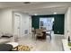 This spacious dining area opens to a modern kitchen and has a decorative green accent wall at 2613 E 23Rd Ave, Tampa, FL 33605