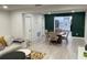This spacious dining area opens to a modern kitchen and has a decorative green accent wall at 2613 E 23Rd Ave, Tampa, FL 33605
