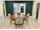 Bright dining room featuring a round wood table set and a view into the modern kitchen at 2613 E 23Rd Ave, Tampa, FL 33605