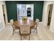 Bright dining room featuring a round wood table set and a view into the modern kitchen at 2613 E 23Rd Ave, Tampa, FL 33605