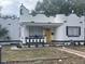 Charming Spanish style home features unique architectural details, a yellow door, and a well manicured front yard at 2613 E 23Rd Ave, Tampa, FL 33605