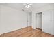 Bright bedroom with a ceiling fan, wood-look floors, and a closet at 30613 Midtown Ct, Wesley Chapel, FL 33545