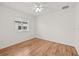 Bright bedroom with a ceiling fan and wood-look flooring at 30613 Midtown Ct, Wesley Chapel, FL 33545