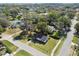 Overhead view of a charming single-story home surrounded by lush greenery in a quiet neighborhood at 38638 2Nd Ave, Zephyrhills, FL 33542