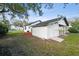 Backyard with a shed and an air conditioning unit, with a view of neighboring houses at 38638 2Nd Ave, Zephyrhills, FL 33542