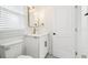 Well-lit bathroom features a modern vanity with gold fixtures and decorative floor tiling at 38638 2Nd Ave, Zephyrhills, FL 33542