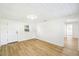 Simple, bright bedroom with hardwood floors, white ceilings and walls and modern lighting at 38638 2Nd Ave, Zephyrhills, FL 33542