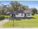 Inviting single-story home featuring a covered carport and lush green lawn at 38638 2Nd Ave, Zephyrhills, FL 33542