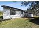 Rear exterior with a wooden deck and an air conditioning unit at 38638 2Nd Ave, Zephyrhills, FL 33542