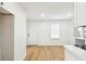 Bright living room area featuring hardwood floors, white walls and trim, and recessed lighting at 38638 2Nd Ave, Zephyrhills, FL 33542