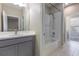Bright bathroom features a gray vanity, shower/tub combo, and access to the adjacent toilet and bedroom at 4549 Chinkapin Dr, Sarasota, FL 34232