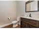 Charming powder room with a dark wood vanity, white countertop, and a decorative mirror with oil rubbed bronze faucet at 4549 Chinkapin Dr, Sarasota, FL 34232