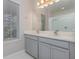 Bathroom with double sinks, walk-in shower, and quartz counters at 4549 Chinkapin Dr, Sarasota, FL 34232