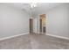 Spacious, carpeted bedroom with a ceiling fan and a view into an en-suite bathroom with gray vanity at 4549 Chinkapin Dr, Sarasota, FL 34232