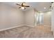 Bedroom with carpet, ceiling fan, two doors, and a hallway at 4549 Chinkapin Dr, Sarasota, FL 34232