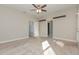 Bedroom with carpet, ceiling fan, two doors, and two shelves at 4549 Chinkapin Dr, Sarasota, FL 34232