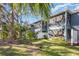 Back exterior of townhome with a screened porch, backyard, and trees at 4549 Chinkapin Dr, Sarasota, FL 34232