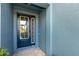 Stylish front door with glass accents, framed by the home's exterior and manicured plants at 4549 Chinkapin Dr, Sarasota, FL 34232
