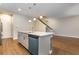 Kitchen island features stone counters, stainless steel dishwasher, and sink with pendant lights above, opening to living area at 4549 Chinkapin Dr, Sarasota, FL 34232