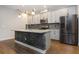 Modern kitchen features stainless steel appliances, stone countertops, and a brick-accented island with pendant lighting at 4549 Chinkapin Dr, Sarasota, FL 34232