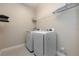 Laundry room with white washer and dryer and storage shelf at 4549 Chinkapin Dr, Sarasota, FL 34232