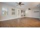 Bright living room with wood-look tile flooring, ceiling fans, and access to the outdoor area at 4549 Chinkapin Dr, Sarasota, FL 34232