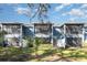 Blue condominium with screened balconies overlooking a well maintained and landscaped lawn at 4549 Chinkapin Dr, Sarasota, FL 34232