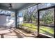 Screened porch overlooking backyard with trees and landscaping at 4549 Chinkapin Dr, Sarasota, FL 34232